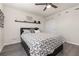Cozy bedroom featuring a heart-patterned duvet cover, floating shelf decor, and modern ceiling fan at 2623 Buena View Rd, Kissimmee, FL 34746