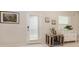 Bright entryway featuring a white door, decorative accents, and a cozy dog crate, offering a welcoming first impression at 2623 Buena View Rd, Kissimmee, FL 34746