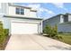 Home exterior featuring a driveway leading to an attached garage at 2623 Buena View Rd, Kissimmee, FL 34746