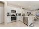 Bright kitchen boasts stainless steel appliances, white cabinets, tile backsplash, and an eat-in island at 2623 Buena View Rd, Kissimmee, FL 34746
