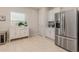 Spacious kitchen with stainless steel refrigerator, white cabinetry, and bright natural light at 2623 Buena View Rd, Kissimmee, FL 34746
