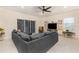 Cozy living room features neutral colors, ceiling fan, and sliding glass doors at 2623 Buena View Rd, Kissimmee, FL 34746