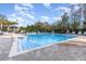 Community swimming pool featuring refreshing blue water, lounge chairs, and lush landscaping at 2623 Buena View Rd, Kissimmee, FL 34746