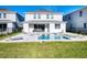 A home backyard with a pool, spa, lounge chairs and eating area at 300 Burma St, Kissimmee, FL 34747