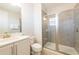 Modern bathroom boasts a glass-enclosed shower with tile surround, a sleek vanity, and contemporary fixtures at 300 Burma St, Kissimmee, FL 34747