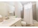 Clean bathroom featuring a vanity with a white countertop, toilet, and a shower with a white curtain at 300 Burma St, Kissimmee, FL 34747