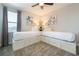 Cozy bedroom featuring two twin beds with built-in storage, bedside lamps, and neutral decor at 300 Burma St, Kissimmee, FL 34747