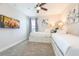 Charming bedroom with twin beds, built-in storage, TV and a calming color scheme at 300 Burma St, Kissimmee, FL 34747