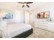 Bright bedroom featuring a large bed, modern white dresser, and a flat-screen TV for entertainment at 300 Burma St, Kissimmee, FL 34747