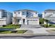 Beautiful two-story home with a well-manicured front yard, brick driveway, and a two car garage at 300 Burma St, Kissimmee, FL 34747