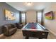 Game room features an air hockey table, two chairs and flat screen TV at 300 Burma St, Kissimmee, FL 34747