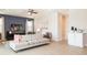 Bright and airy living room with a large couch, a ceiling fan, and neutral-colored walls at 300 Burma St, Kissimmee, FL 34747
