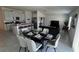Well-staged dining area features an oval dining table, chairs, and flows into the living space at 313 Estates Ct, Haines City, FL 33844