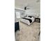 Comfortable main bedroom featuring carpeted floors, a ceiling fan, and a large bed with bedside tables at 313 Estates Ct, Haines City, FL 33844