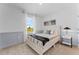 A cozy bedroom with a large window, plush bedding, and stylish decor at 3350 Private Oak Dr, Apopka, FL 32703
