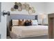 Cozy bedroom showcases decorative wall hangings above the headboard and stylish nightstand at 3350 Private Oak Dr, Apopka, FL 32703