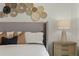 Cozy bedroom showcases decorative wall hangings above the headboard and stylish nightstand at 3350 Private Oak Dr, Apopka, FL 32703