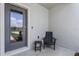 A charming front porch seating area next to a large glass-paneled front door at 3350 Private Oak Dr, Apopka, FL 32703