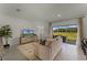Relaxing living room features a plush sofa, entertainment center, and sliding glass doors to the patio at 3350 Private Oak Dr, Apopka, FL 32703