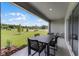 Covered patio features an outdoor dining set and a view of the lush green lawn at 3350 Private Oak Dr, Apopka, FL 32703
