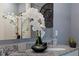 Bathroom vanity with granite countertops, modern decor, a decorative mirror, and a stylish decorative plant at 3362 Private Oak Dr, Apopka, FL 32703