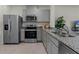 Modern kitchen featuring stainless steel appliances, granite countertops, and ample cabinet space at 3368 Private Oak Dr, Apopka, FL 32703
