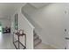 Staircase with carpeted steps, white banister, and tiled landing; adjacent to a stylish console table at 3368 Private Oak Dr, Apopka, FL 32703