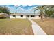 Charming one-story home featuring a well-maintained lawn, walkway, and neutral-toned paint scheme with a palm tree in the front yard at 345 Overstreet Ave, Longwood, FL 32750