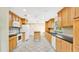 Well-lit kitchen with granite counters, custom cabinets and tile floors at 345 Overstreet Ave, Longwood, FL 32750