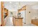 Bright kitchen with an island, tile floors, wood cabinets, and white appliances offers ample space and storage at 345 Overstreet Ave, Longwood, FL 32750