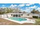 Back of home with screen porch and swimming pool, white pool deck, and green grass at 345 Overstreet Ave, Longwood, FL 32750