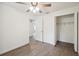 Bedroom featuring a ceiling fan, closet with wire shelving, and entry to the house at 38934 Merrell Ave, Umatilla, FL 32784