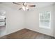Bedroom featuring a ceiling fan, window, and doorway leading to the kitchen at 38934 Merrell Ave, Umatilla, FL 32784
