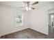 Bright bedroom featuring a ceiling fan, a window, and an entry to the house at 38934 Merrell Ave, Umatilla, FL 32784