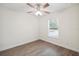 Bright bedroom with a ceiling fan, window, and wood-look flooring at 38934 Merrell Ave, Umatilla, FL 32784