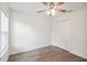 Bedroom featuring a ceiling fan, closet, window, and wood-look floors at 38934 Merrell Ave, Umatilla, FL 32784