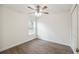 Bright bedroom with a ceiling fan, window, and wood-look flooring with closet at 38934 Merrell Ave, Umatilla, FL 32784