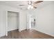 Bedroom featuring a ceiling fan, closet, and doorway leading to the house at 38934 Merrell Ave, Umatilla, FL 32784