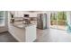 Modern kitchen featuring stainless steel appliances, granite countertops, and a view to the backyard at 38934 Merrell Ave, Umatilla, FL 32784