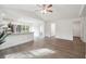 Bright and airy living space flows into the kitchen, featuring modern finishes and ample natural light at 38934 Merrell Ave, Umatilla, FL 32784