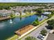 Aerial view of the community featuring a lake with a fountain, pool, tennis courts, and clubhouse at 4008 San Gallo Dr # 102, Kissimmee, FL 34741