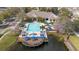 Aerial view of the community pool, hot tub, clubhouse, and deck overlooking the water at 4008 San Gallo Dr # 102, Kissimmee, FL 34741