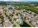 Beautiful aerial view of townhome community, highlighting the pool, lush landscaping, and serene waterfront at 4008 San Gallo Dr # 102, Kissimmee, FL 34741