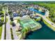Aerial view showcasing the community's tennis courts, playgrounds, and scenic waterfront, surrounded by lush greenery at 4008 San Gallo Dr # 102, Kissimmee, FL 34741