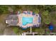 Aerial view of the community pool, clubhouse, lounge chairs, tables, and playground at 4008 San Gallo Dr # 102, Kissimmee, FL 34741