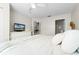 Bright bedroom with ceiling fan and a television and a view to the en suite bathroom at 4008 San Gallo Dr # 102, Kissimmee, FL 34741