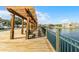 Scenic waterfront pier with benches and a wooden pergola, offering a tranquil space by the water at 4008 San Gallo Dr # 102, Kissimmee, FL 34741