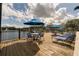 Wooden deck with lounge chairs and tables overlooking the water at 4008 San Gallo Dr # 102, Kissimmee, FL 34741