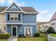 Charming blue two-story townhouse with a cozy front porch bench and well-manicured landscaping at 4008 San Gallo Dr # 102, Kissimmee, FL 34741