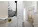 Hallway with in-unit washer/dryer in a closet and bathroom with shower and tub in view at 4008 San Gallo Dr # 102, Kissimmee, FL 34741